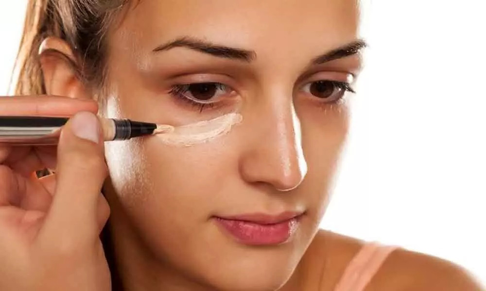 Applying concealer